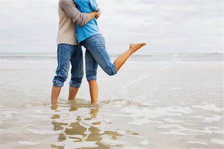 rolled up (clothing) - Couple hugging in the sea Stock Photo - Premium Royalty-Free, Code: 614-02640357