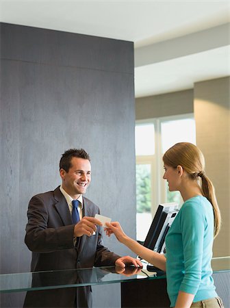 Woman checking into a hotel Stock Photo - Premium Royalty-Free, Code: 614-02680075