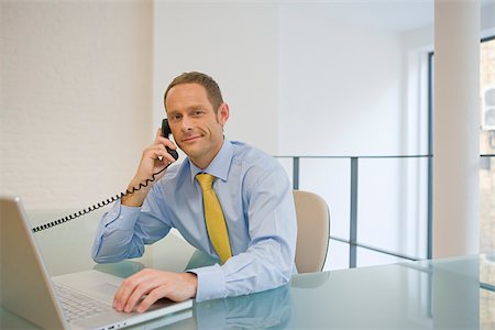 Office worker on telephone Stock Photo - Premium Royalty-Free, Code: 614-02680155