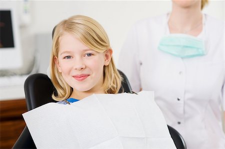 female dentist looking at camera - Girl in dentists office Stock Photo - Premium Royalty-Free, Code: 614-02740194