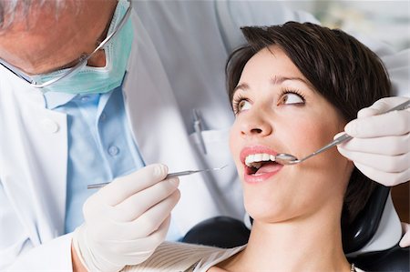 specchio da dentista - Woman having dental check up Fotografie stock - Premium Royalty-Free, Codice: 614-02740200