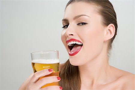 people drinking beer smiling - Woman drinking a pint of lager Stock Photo - Premium Royalty-Free, Code: 614-02740363