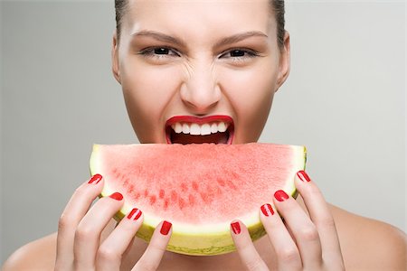 Young woman eating watermelon Stock Photo - Premium Royalty-Free, Code: 614-02740435