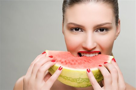 Young woman eating watermelon Stock Photo - Premium Royalty-Free, Code: 614-02740430