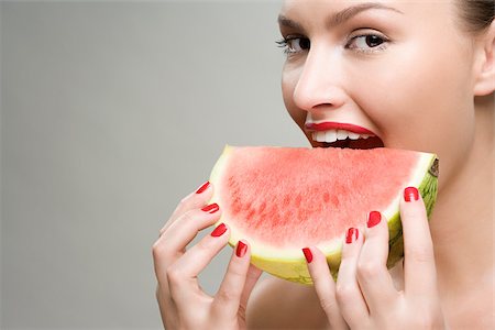 Young woman eating watermelon Stock Photo - Premium Royalty-Free, Code: 614-02740445