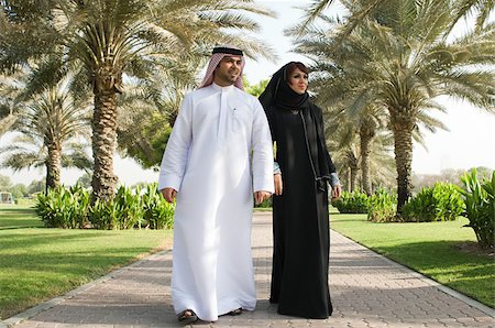 dishdasha - A couple walking in a park Stock Photo - Premium Royalty-Free, Code: 614-02764054