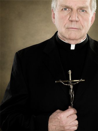 priest - A priest holding a crucifix Stock Photo - Premium Royalty-Free, Code: 614-02764140