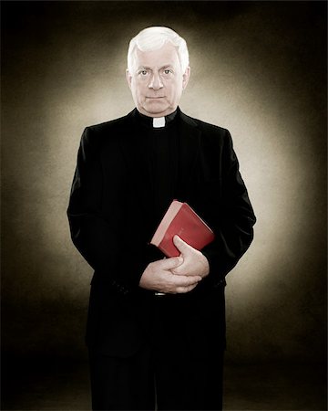 priest - Portrait of a priest holding a bible Stock Photo - Premium Royalty-Free, Code: 614-02764178