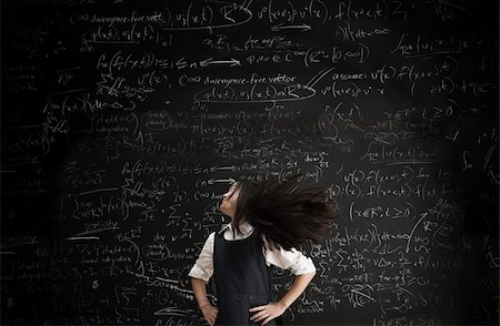 Girl moving in front of blackboard Stock Photo - Premium Royalty-Free, Code: 614-02762654