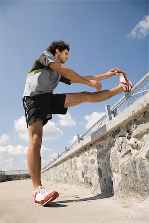 runner legs - Man stretching his leg Stock Photo - Premium Royalty-Free, Code: 614-02763003