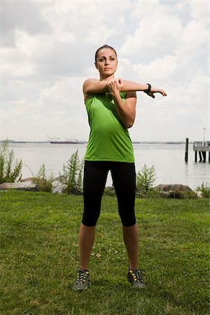 female athlete stretching - Runner stretching arm Stock Photo - Premium Royalty-Free, Code: 614-02763031