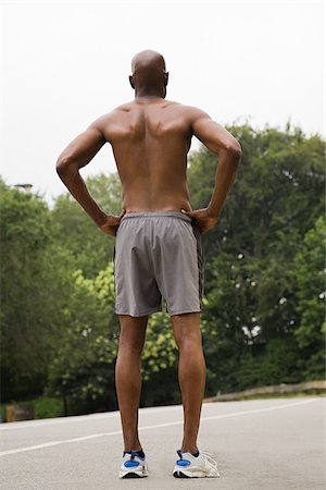 Rear view of runner on road Stock Photo - Premium Royalty-Free, Code: 614-02763040