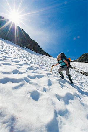 A female climber walking down a mountain Stock Photo - Premium Royalty-Free, Code: 614-02763245