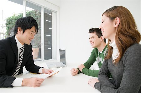 suit business people meeting laptop ethnic - A businessman in a meeting with clients Stock Photo - Premium Royalty-Free, Code: 614-02838215