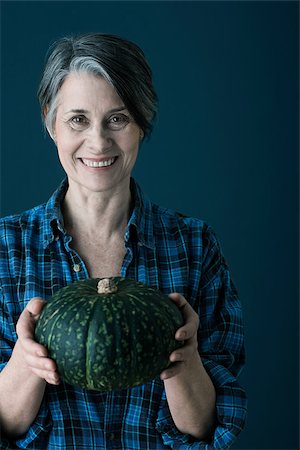 Woman holding pumpkin Stock Photo - Premium Royalty-Free, Code: 614-02838702