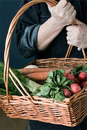 Person with basket of vegetables Stock Photo - Premium Royalty-Free, Code: 614-02838727