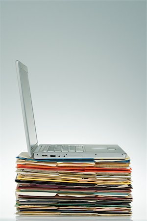 paper work stacked - Laptop on files Stock Photo - Premium Royalty-Free, Code: 614-02838762