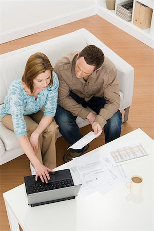 Couple sitting on couch Stock Photo - Premium Royalty-Free, Code: 614-02934182