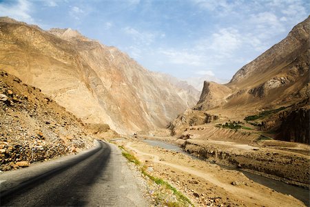 road desert nobody - Road winding through gorge next to river Stock Photo - Premium Royalty-Free, Code: 614-02934288