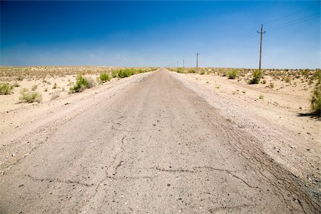 Cracked road stretching through the desert Stock Photo - Premium Royalty-Free, Code: 614-02934298