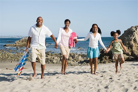 African american family on a beach Stock Photo - Premium Royalty-Free, Code: 614-02934571