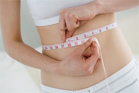 fitness home - Woman measuring waist Foto de stock - Sin royalties Premium, Código: 614-02933901