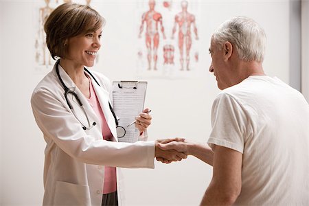 simsearch:614-02984110,k - Doctor shaking hands with patient Fotografie stock - Premium Royalty-Free, Codice: 614-02984148