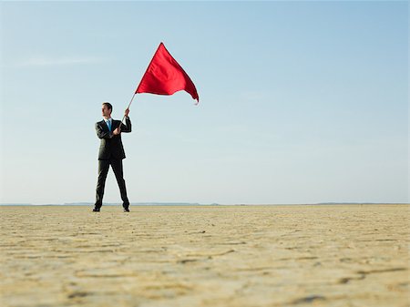 Homme tenant un drapeau rouge Photographie de stock - Premium Libres de Droits, Code: 614-02984453