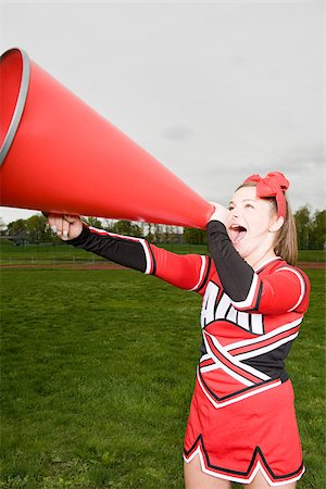 Pom-pom girl avec mégaphone Photographie de stock - Premium Libres de Droits, Code: 614-02984821