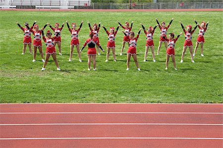 Cheerleaders performing routine Foto de stock - Sin royalties Premium, Código: 614-02984822