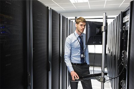 Computer technician working on a server Stock Photo - Premium Royalty-Free, Code: 614-02985071