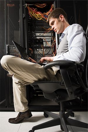 Male computer technician working Stock Photo - Premium Royalty-Free, Code: 614-02985106