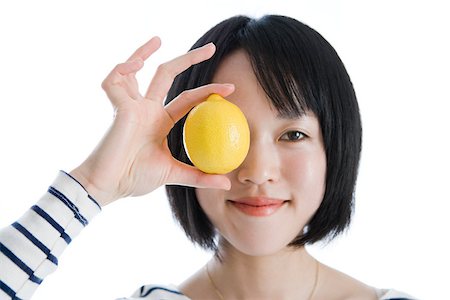 people with fruits cutout - Woman holding a lemon to her eye Stock Photo - Premium Royalty-Free, Code: 614-02985249