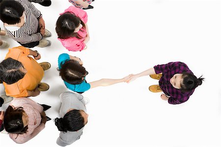 people crowd white background - Woman shaking hands with someone in crowd Stock Photo - Premium Royalty-Free, Code: 614-02983844