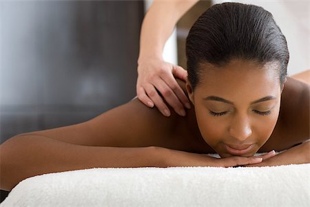 salon african american - Woman having a massage Stock Photo - Premium Royalty-Free, Code: 614-02983951