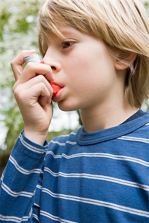 sick outside - Boy taking asthma inhaler Stock Photo - Premium Royalty-Free, Code: 614-03020255