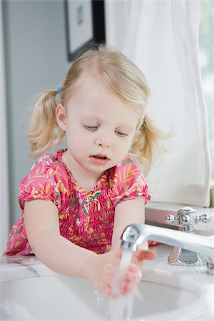 Girl washing her hands Stock Photo - Premium Royalty-Free, Code: 614-03020259
