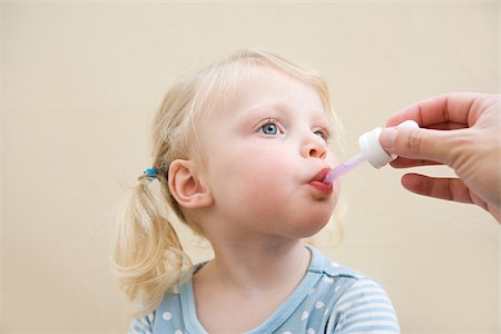 parents with sick baby - Little girl being given medicine Stock Photo - Premium Royalty-Free, Code: 614-03020262