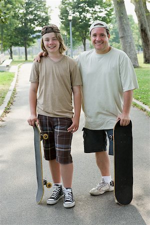 similarity father - Father and son with skateboards Stock Photo - Premium Royalty-Free, Code: 614-03080475