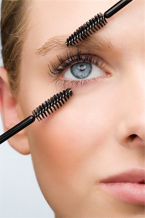 extreme close up human eye - Woman with two mascara brushes Stock Photo - Premium Royalty-Free, Code: 614-03080796