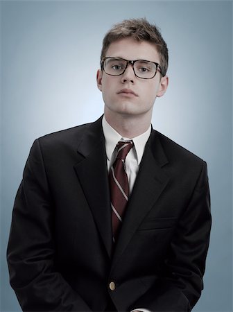 Portrait of a boy in suit and glasses Stock Photo - Premium Royalty-Free, Code: 614-03191044