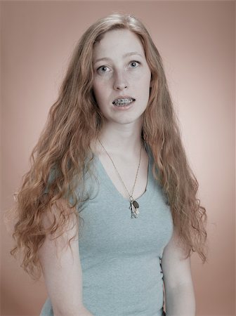 quirky person 20s - Portrait of a woman with dental brace Stock Photo - Premium Royalty-Free, Code: 614-03191048