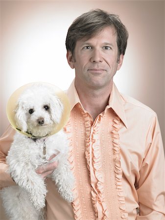 Man with pet poodle Fotografie stock - Premium Royalty-Free, Codice: 614-03191042