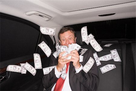 Wealthy businessman in the back of a car Stock Photo - Premium Royalty-Free, Code: 614-03191638