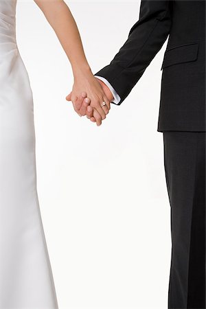 Bride and groom holding hands Fotografie stock - Premium Royalty-Free, Codice: 614-03191776