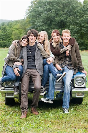 Friends sitting on a car Stock Photo - Premium Royalty-Free, Code: 614-03241300