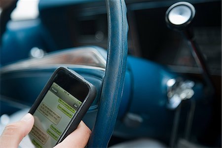 distracted phone - Person driving and using cellphone Stock Photo - Premium Royalty-Free, Code: 614-03241341