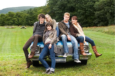 Friends sitting on a car Stock Photo - Premium Royalty-Free, Code: 614-03241379