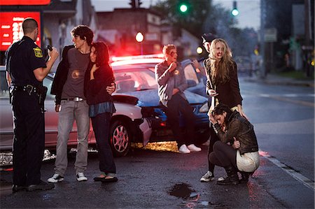 sinister - Young people and police officer at scene of car crash Stock Photo - Premium Royalty-Free, Code: 614-03241383