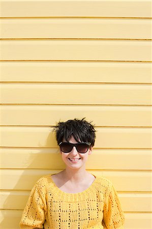 Young woman and yellow wall Stock Photo - Premium Royalty-Free, Code: 614-03241506